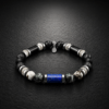 B107 – Bransoletka z Lapisu Lazuli, Serafinitu, Macicy Opalowej, Labradorytu, Onyksu, Lawy Wulkanicznej, Hematytu i Obsydianu Bransoletka z naturalnego lapisu lazuli, serafinitu, macicy opalowej, labradorytu, onyksu, lawy wulkanicznej, hematytu i obsydianu na gumce jubilerskiej ze stalą szlachetną