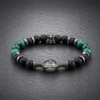B126 – Bransoletka z Prehnitu, Malachitu, Tygrysiego Oka, Onyksu, Lawy Wulkanicznej i Hematytu Bransoletka z naturalnego prehnitu, malachitu, tygrysiego oka, onyksu, lawy wulkanicznej i hematytu na gumce jubilerskiej ze stalą szlachetną